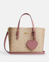 Coach Mollie Tote Signature Beige con Detalles Rosa y Charm de Corazón